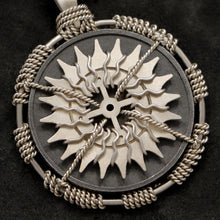 Load image into Gallery viewer, Detail view of 18K Palladium White Gold and Sterling Silver Sewn Gold Metal Compass pendant featuring 20 pointed gear by Caps Brothers