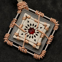 Load image into Gallery viewer, Detail view of 18K Rose Gold and 18K Palladium White Gold and Sterling Silver and Ruby Sewn Gold Metal Confidence pendant featuring 4 pointed gear by Caps Brothers