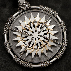 Detail view of Sterling Silver and 18K Yellow Gold Accents Sewn Silver Metal Sun pendant featuring 20 pointed gear by Caps Brothers
