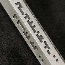 Load image into Gallery viewer, Detail view of Code of Wisdom hexagonal sterling silver pendant and chain with endless loop necklace featuring Binary Code by Caps Brothers
