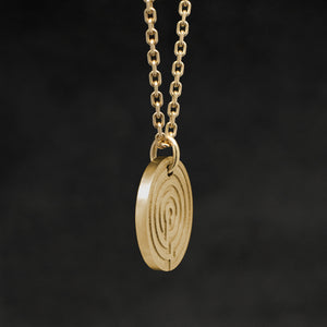 Side view of 18K Yellow Gold Journey pendant and chain with endless loop necklace featuring labyrinth as inward journey by Caps Brothers