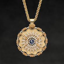 Load image into Gallery viewer, Hanging front view of 18K Yellow Gold and 18K Palladium White Gold and Sapphire Sewn Gold Metal Majesty pendant and chain with endless loop necklace featuring 20 pointed gear by Caps Brothers