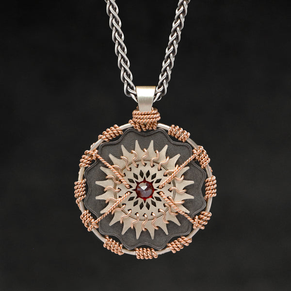 Hanging front view of 18K Rose Gold and 18K Palladium White Gold and Sterling Silver and Ruby Sewn Gold Metal Majesty pendant and chain with endless loop necklace featuring 20 pointed gear by Caps Brothers