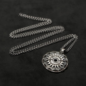 Laying down view of Sterling Silver and 18K Palladium White Gold Accents and Black Sapphire Sewn Silver Metal Majesty pendant and chain with endless loop necklace featuring 20 pointed gear by Caps Brothers
