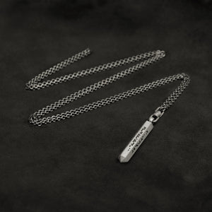 Laying down Code of Wisdom hexagonal sterling silver pendant and chain with endless loop necklace featuring Binary Code by Caps Brothers