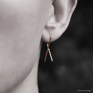Model wearing 18K Rose Gold Sibling Ribbon Twisted Earring representing we are all brothers and sisters by Caps Brothers