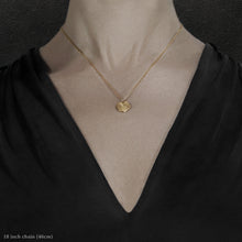 Load image into Gallery viewer, Closeup of model wearing 18K Yellow Gold Journey pendant and chain necklace featuring the Map of Humanity as outward journey by Caps Brothers