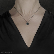 Load image into Gallery viewer, Closeup of model wearing Sterling Silver Journey pendant and chain necklace featuring the Map of Humanity as outward journey by Caps Brothers