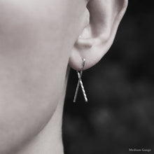 Load image into Gallery viewer, Model wearing Sterling Silver Sibling Ribbon Classic Earring representing we are all brothers and sisters by Caps Brothers