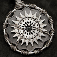 Detail view of Sterling Silver and 18K Palladium White Gold Accents and Black Sapphire Sewn Silver Metal Majesty pendant featuring 20 pointed gear by Caps Brothers