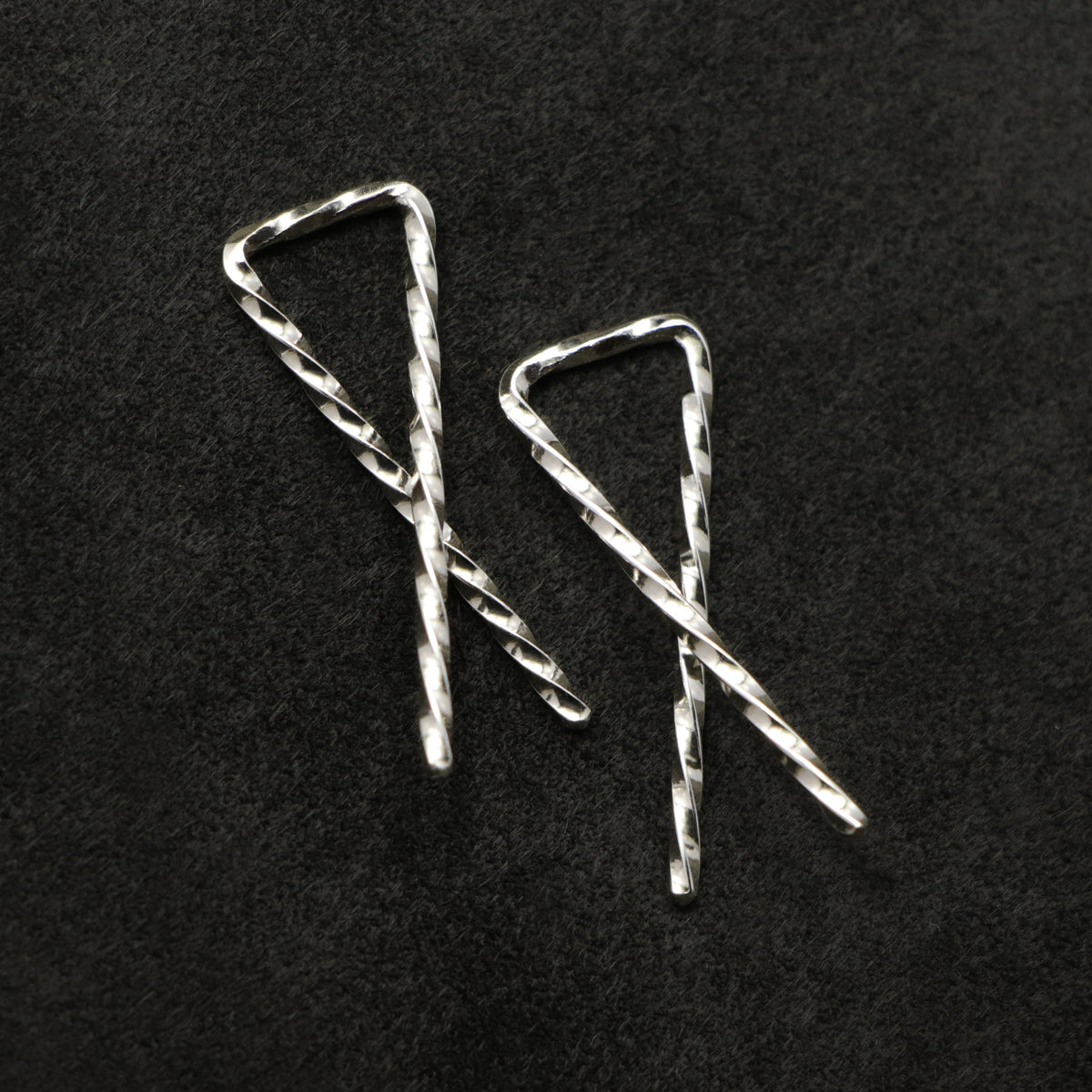 Detail view of Sibling Ribbons in Sterling Silver earring representing we are all brothers and sisters by Caps Brothers
