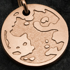 Detail view of 18K Rose Gold Journey pendant featuring the Map of Humanity as outward journey by Caps Brothers