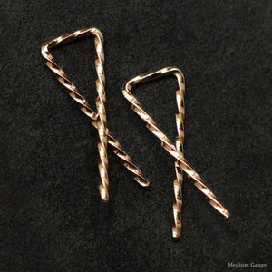 Detail view of 18K Rose Gold Sibling Ribbons Twisted Earrings representing we are all brothers and sisters by Caps Brothers