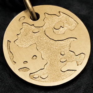 Detail view of 18K Yellow Gold Journey pendant featuring the Map of Humanity as outward journey by Caps Brothers