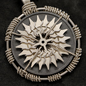Detail view of 18K Palladium White Gold and Sterling Silver Sewn Gold Metal Compass pendant featuring 20 pointed gear by Caps Brothers
