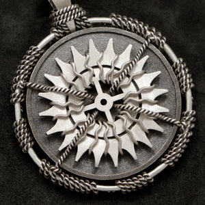 Detail view of Sterling Silver and 18K Palladium White Gold Accents Sewn Silver Metal Compass pendant featuring 20 pointed gear by Caps Brothers