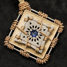 Load image into Gallery viewer, Detail view of 18K Yellow Gold and 18K Palladium White Gold and Sapphire Sewn Gold Metal Confidence pendant featuring 4 pointed gear by Caps Brothers