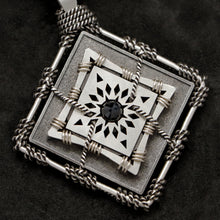 Load image into Gallery viewer, Detail view of Sterling Silver and 18K Palladium White Gold Accents and Black Sapphire Sewn Silver Metal Confidence pendant featuring 4 pointed gear by Caps Brothers