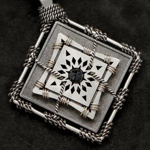 Detail view of Sterling Silver and 18K Palladium White Gold Accents and Black Sapphire Sewn Silver Metal Confidence pendant featuring 4 pointed gear by Caps Brothers