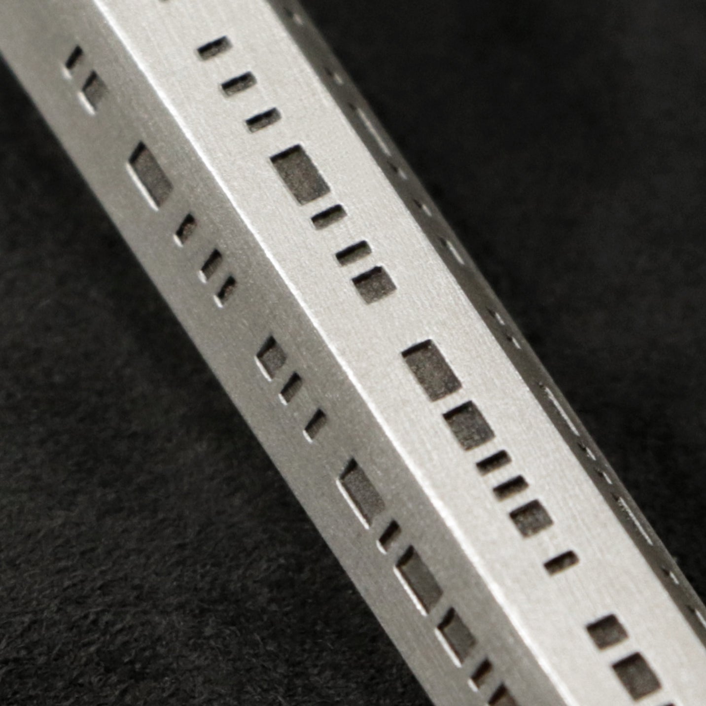 Detail view of Code of Integrity hexagonal sterling silver pendant and chain with endless loop necklace featuring Truncated Barcode by Caps Brothers