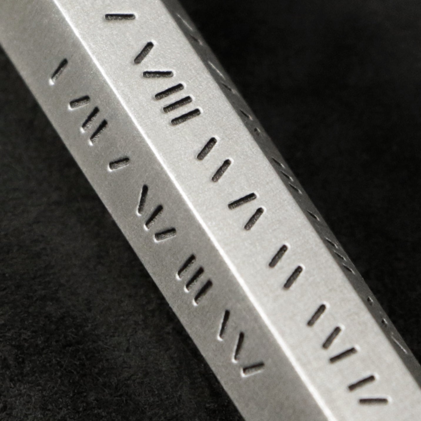 Detail view of Code of Power hexagonal sterling silver pendant and chain with endless loop necklace featuring Abbreviated Roman Letter Numerals Code by Caps Brothers