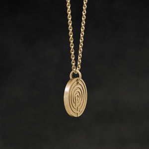 Side view of 18K Yellow Gold Journey pendant and chain necklace featuring labyrinth as inward journey by Caps Brothers