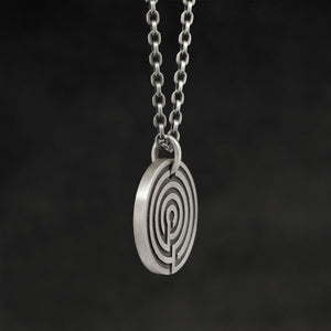 Side view of Sterling Silver Journey pendant and chain with endless loop necklace featuring labyrinth as inward journey by Caps Brothers
