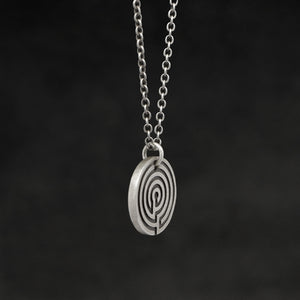 Side view of Sterling Silver Journey pendant and chain necklace featuring labyrinth as inward journey by Caps Brothers