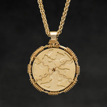 Load image into Gallery viewer, Hanging reverse view of 18K Yellow Gold Sewn Gold Metal Sun pendant and chain with endless loop necklace featuring Map of Humanity by Caps Brothers