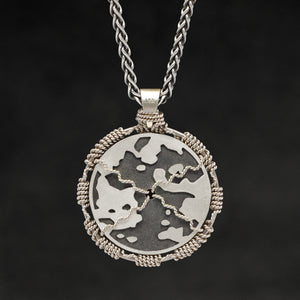 Hanging reverse view of 18K Palladium White Gold and Sterling Silver Sewn Gold Metal Compass pendant and chain with endless loop necklace featuring Map of Humanity by Caps Brothers
