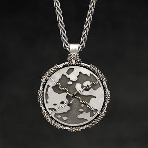 Hanging reverse view of Sterling Silver and 18K Palladium White Gold Accents Sewn Silver Metal Compass pendant and chain with endless loop necklace featuring Map of Humanity by Caps Brothers