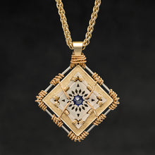 Load image into Gallery viewer, Hanging front view of 18K Yellow Gold and 18K Palladium White Gold and Sapphire Sewn Gold Metal Confidence pendant and chain with endless loop necklace featuring 4 pointed gear by Caps Brothers