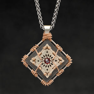 Hanging front view of 18K Rose Gold and 18K Palladium White Gold and Sterling Silver and Ruby Sewn Gold Metal Confidence pendant and chain with endless loop necklace featuring 4 pointed gear by Caps Brothers