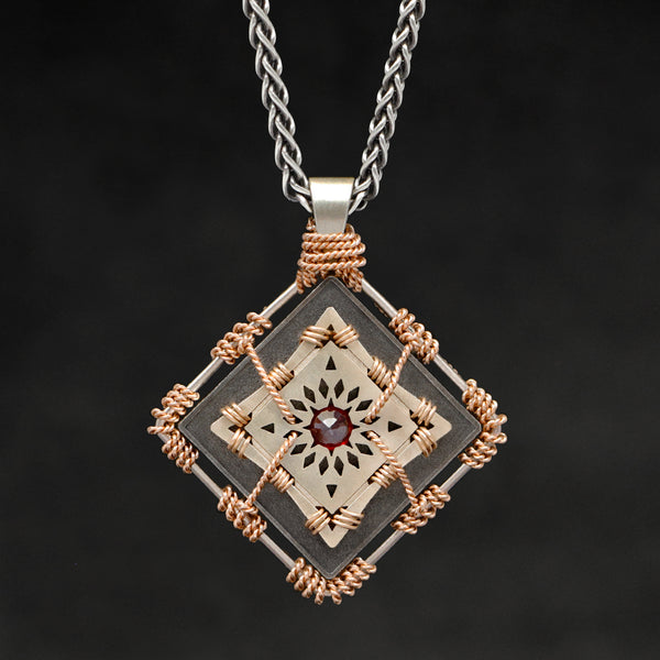 Hanging front view of 18K Rose Gold and 18K Palladium White Gold and Sterling Silver and Ruby Sewn Gold Metal Confidence pendant and chain with endless loop necklace featuring 4 pointed gear by Caps Brothers