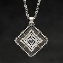 Load image into Gallery viewer, Hanging front view of Sterling Silver and 18K Palladium White Gold Accents and Black Sapphire Sewn Silver Metal Confidence pendant and chain with endless loop necklace featuring 4 pointed gear by Caps Brothers