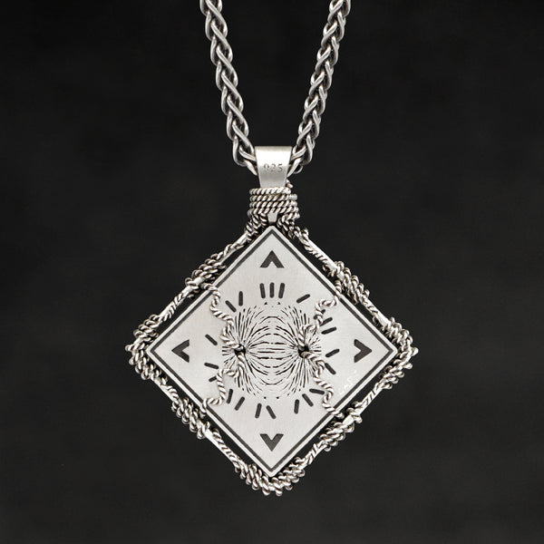 Hanging reverse view of Sterling Silver and 18K Palladium White Gold Accents Sewn Silver Metal Confidence pendant and chain with endless loop necklace featuring Electromagnetic Field and Cardinal Directions by Caps Brothers