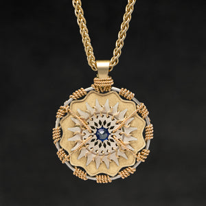 Hanging front view of 18K Yellow Gold and 18K Palladium White Gold and Sapphire Sewn Gold Metal Majesty pendant and chain with endless loop necklace featuring 20 pointed gear by Caps Brothers