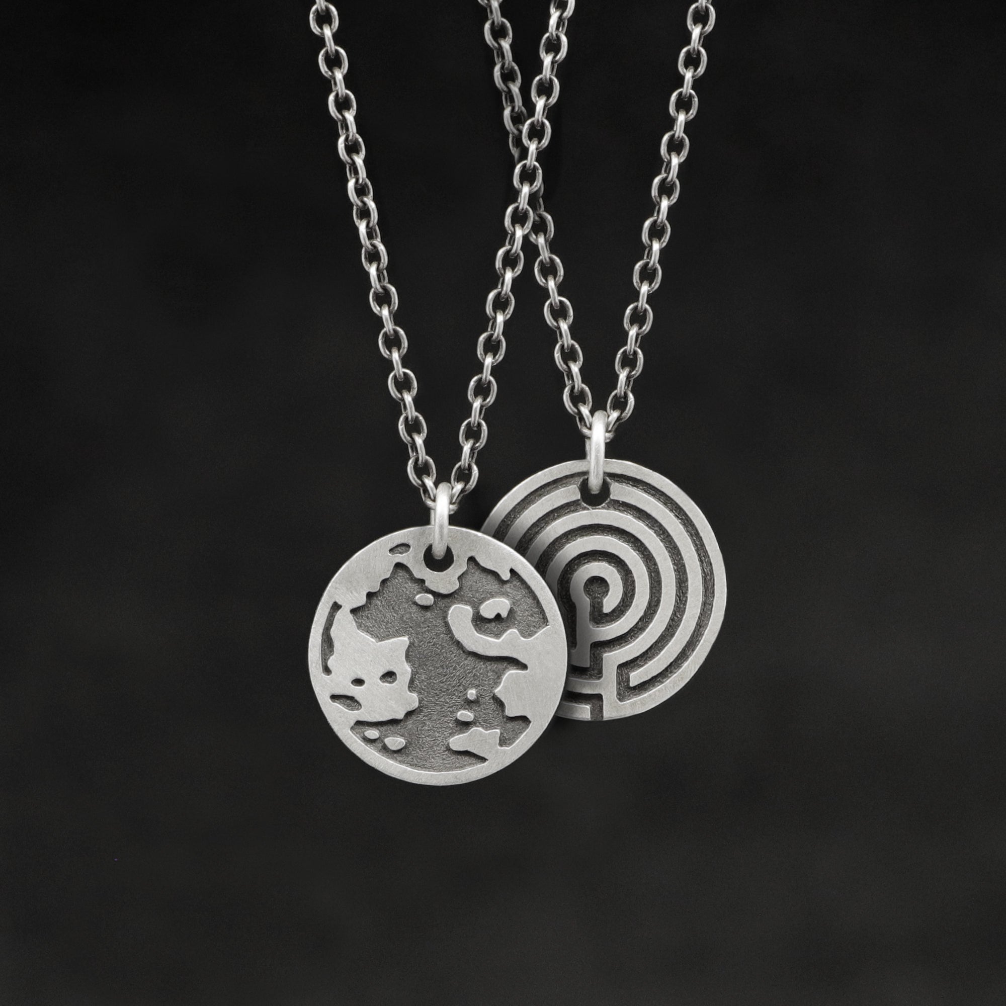 Hanging view of Sterling Silver Journey pendant and chain necklace featuring the Map of Humanity as outward journey and labyrinth as inward journey by Caps Brothers