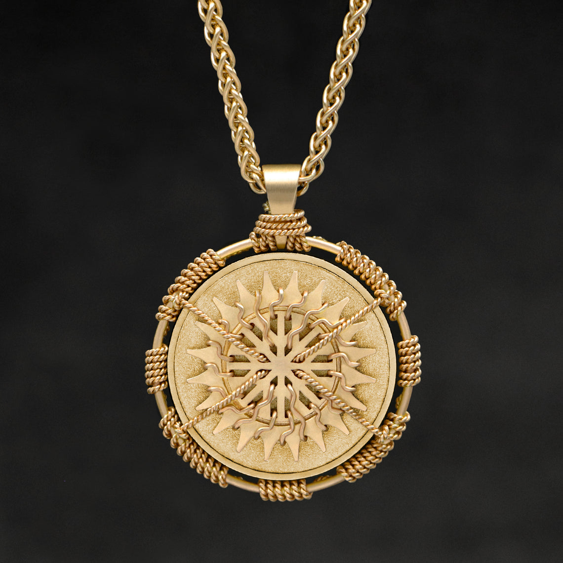 Hanging front view of 18K Yellow Gold Sewn Gold Metal Sun pendant and chain with endless loop necklace featuring 20 pointed gear by Caps Brothers