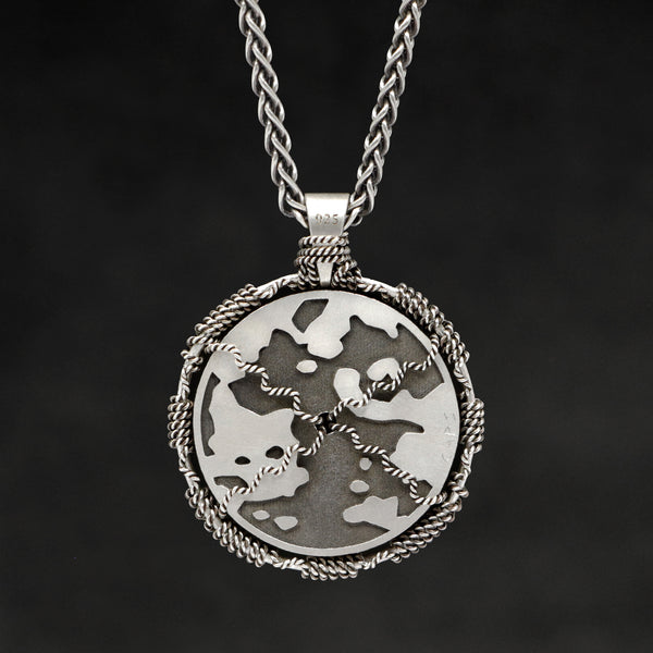 Hanging reverse view of Sterling Silver and 18K Yellow Gold Accents Sewn Silver Metal Sun pendant and chain with endless loop necklace featuring Map of Humanity by Caps Brothers