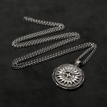 Load image into Gallery viewer, Laying down view of Sterling Silver and 18K Palladium White Gold Accents Sewn Silver Metal Compass pendant and chain with endless loop necklace featuring 20 pointed gear by Caps Brothers