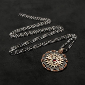 Laying down view of 18K Rose Gold and 18K Palladium White Gold and Sterling Silver and Ruby Sewn Gold Metal Majesty pendant and chain with endless loop necklace featuring 20 pointed gear by Caps Brothers