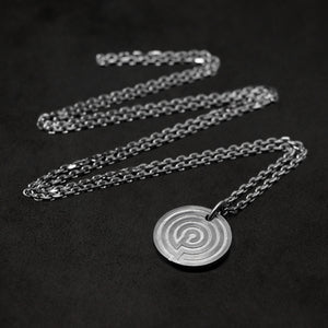 Laying down Platinum 950 Journey pendant and chain with endless loop necklace featuring labyrinth as inward journey by Caps Brothers