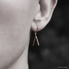 Load image into Gallery viewer, Model wearing 18K Rose Gold Sibling Ribbon Twisted Earring representing we are all brothers and sisters by Caps Brothers