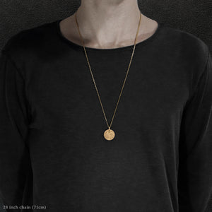Model wearing 18K Yellow Gold Journey pendant and chain with endless loop necklace featuring the Map of Humanity as outward journey by Caps Brothers
