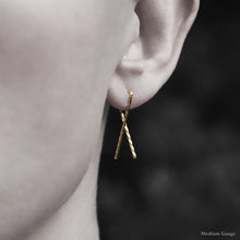 Load image into Gallery viewer, Model wearing 18K Yellow Gold Sibling Ribbon Twisted Earring representing we are all brothers and sisters by Caps Brothers