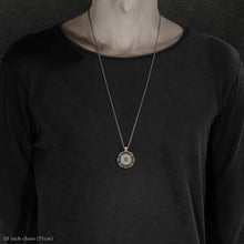 Load image into Gallery viewer, Model wearing 18K Palladium White Gold and Sterling Silver Sewn Gold Metal Compass pendant and chain with endless loop necklace featuring 20 pointed gear by Caps Brothers