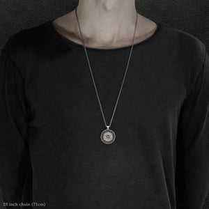 Model wearing Sterling Silver and 18K Palladium White Gold Accents Sewn Silver Metal Compass pendant and chain with endless loop necklace featuring 20 pointed gear by Caps Brothers