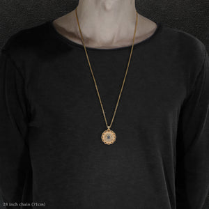Model wearing 18K Yellow Gold and 18K Palladium White Gold and Sapphire Sewn Gold Metal Majesty pendant and chain with endless loop necklace featuring 20 pointed gear by Caps Brothers