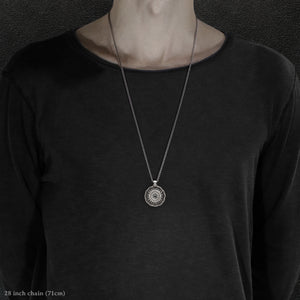 Model wearing Sterling Silver and 18K Palladium White Gold Accents and Black Sapphire Sewn Silver Metal Majesty pendant and chain with endless loop necklace featuring 20 pointed gear by Caps Brothers